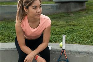 Girl Sitting with Tennis Racket